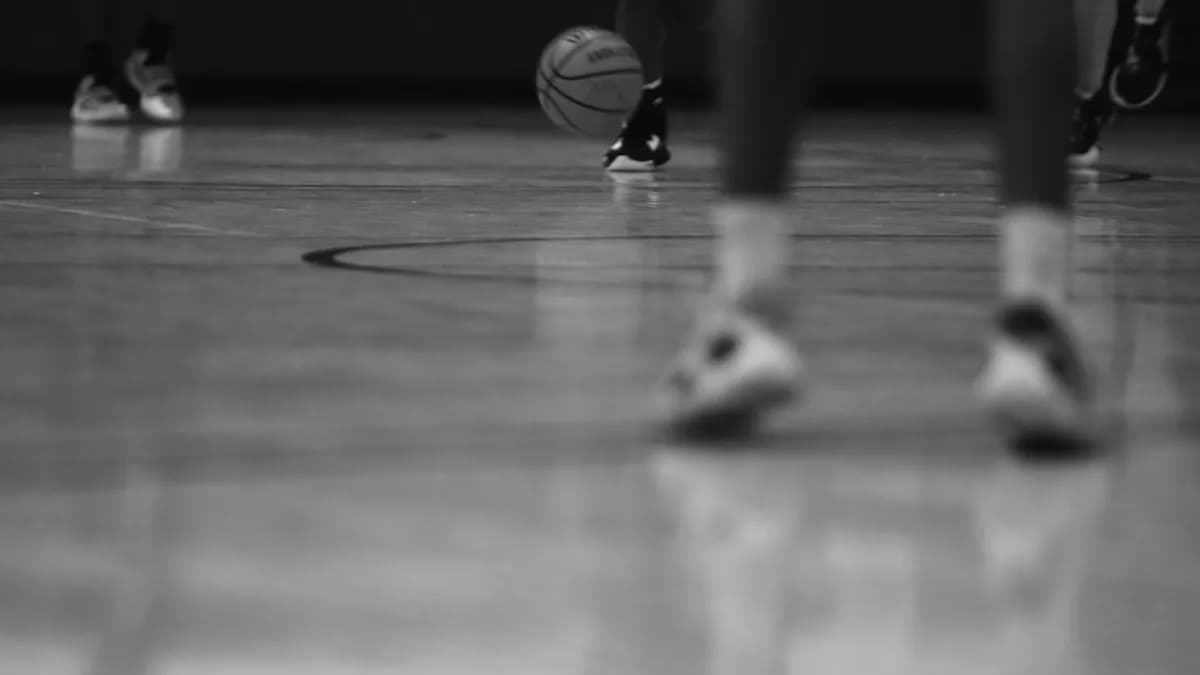 a group of people standing on top of a basketball court