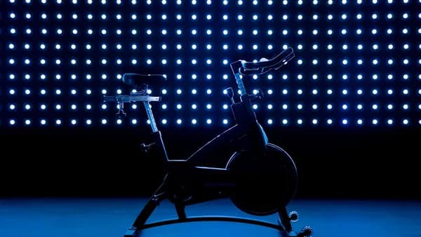 a stationary exercise bike in front of a blue background
