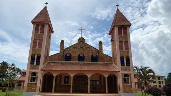 a church with two towers and a cross on top