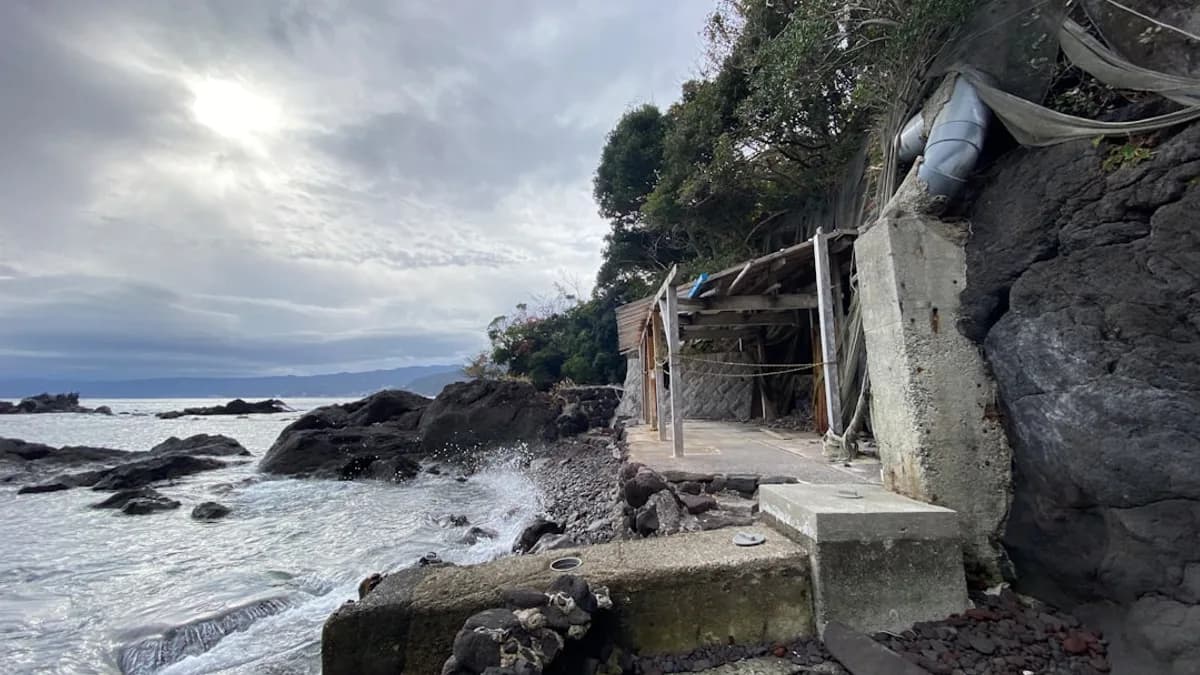 a rocky shore line with a house on it