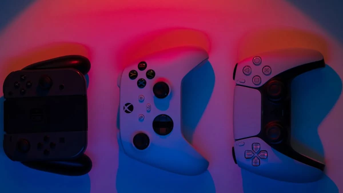 a group of three video game controllers sitting next to each other