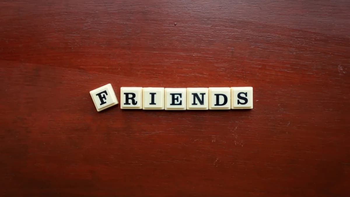 the word friends spelled with scrabbles on a wooden surface