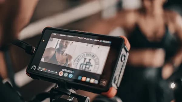 black camera viewing woman smiling