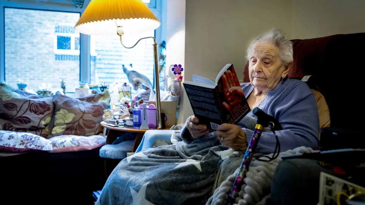a woman sitting in a chair reading a book
