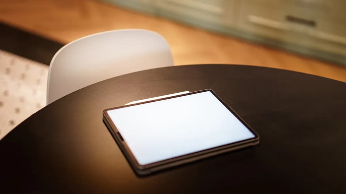 A cell phone sitting on top of a wooden table
