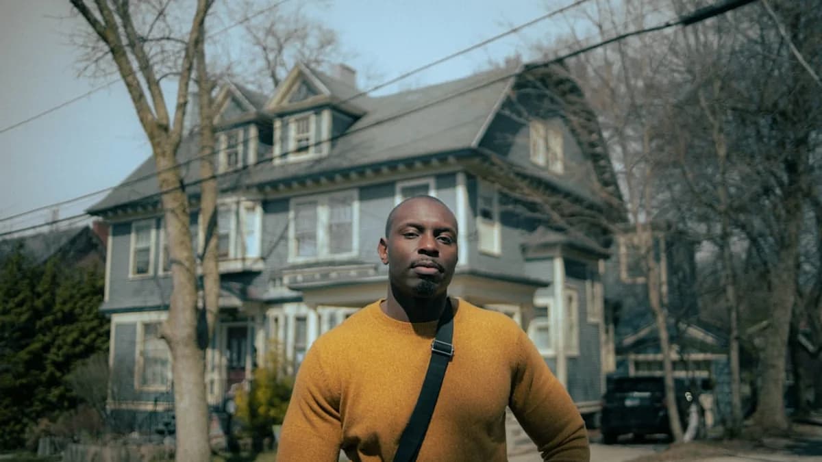 man in yellow crew neck long sleeve shirt standing near building during daytime