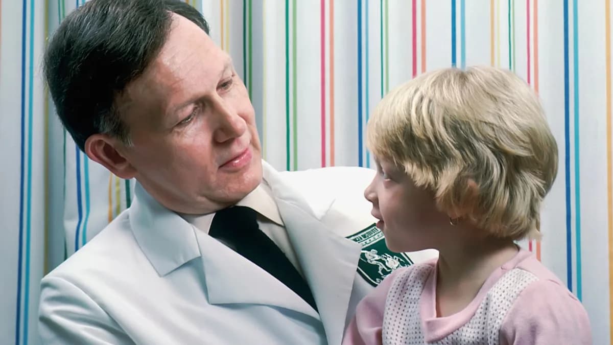 man in white dress shirt beside woman in pink and white polka dot shirt
