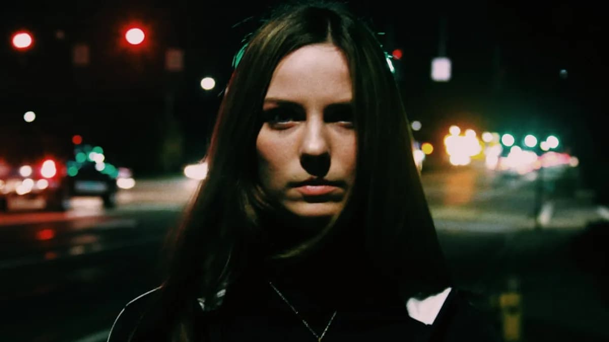 woman standing near city road during nighttime