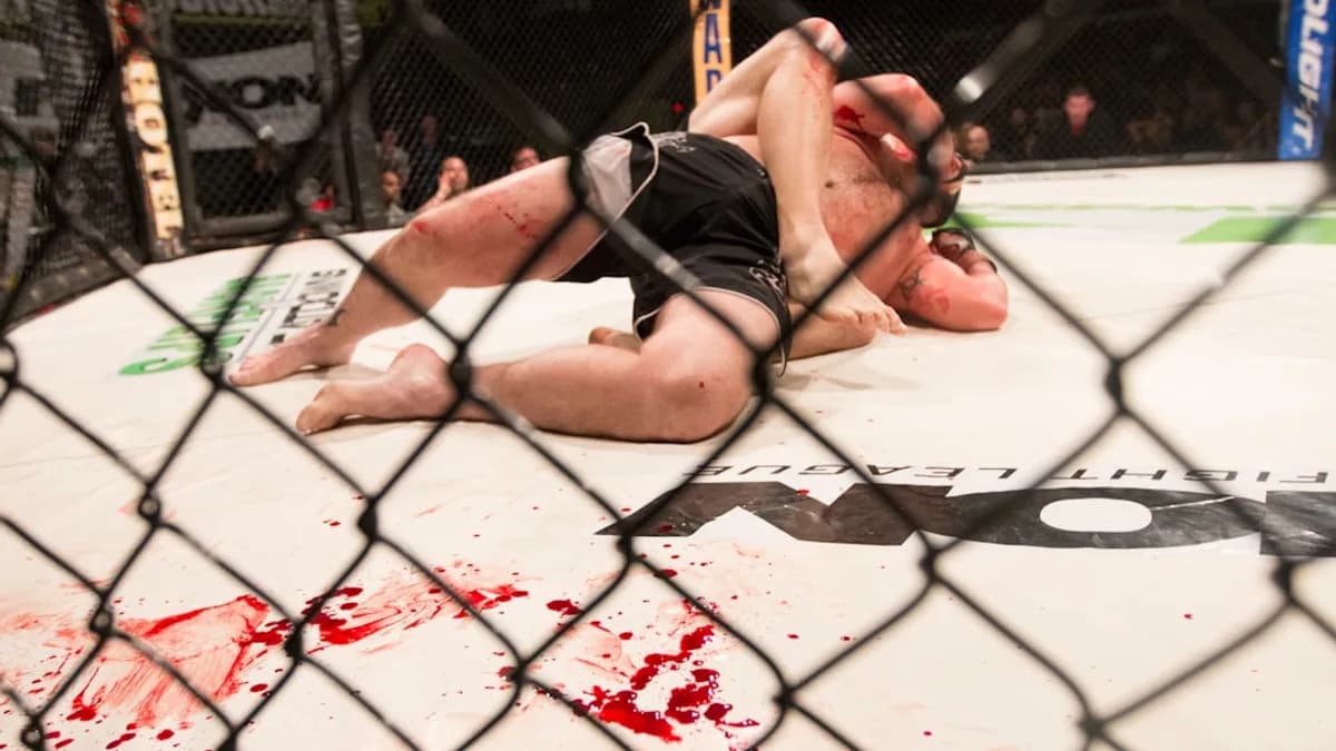a man laying on top of a wrestling ring