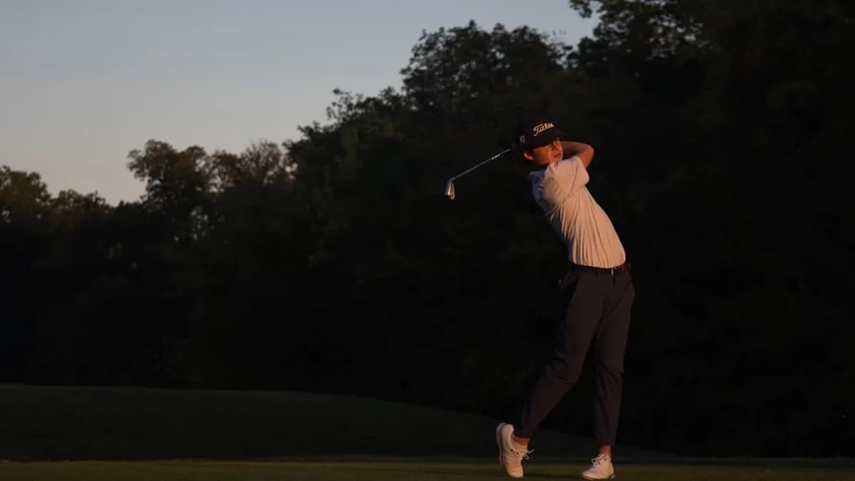 a man swinging a golf club on a golf course