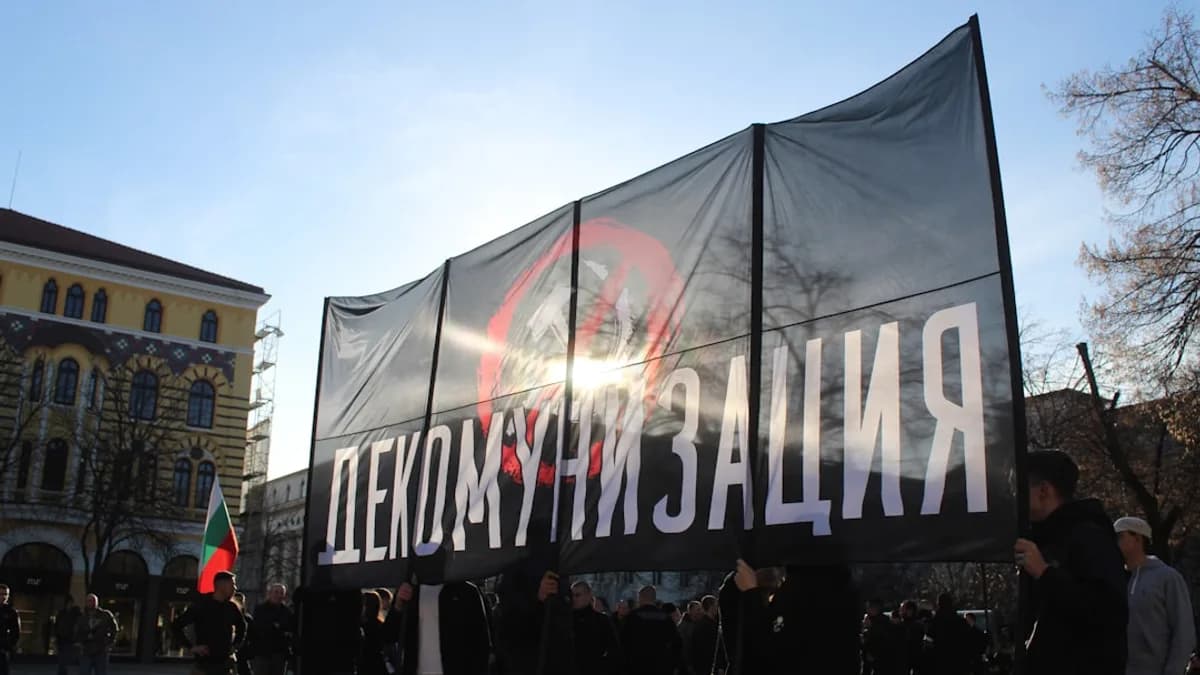 A group of people standing around a large sign