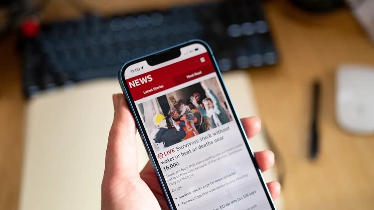 a person holding a cell phone in their hand