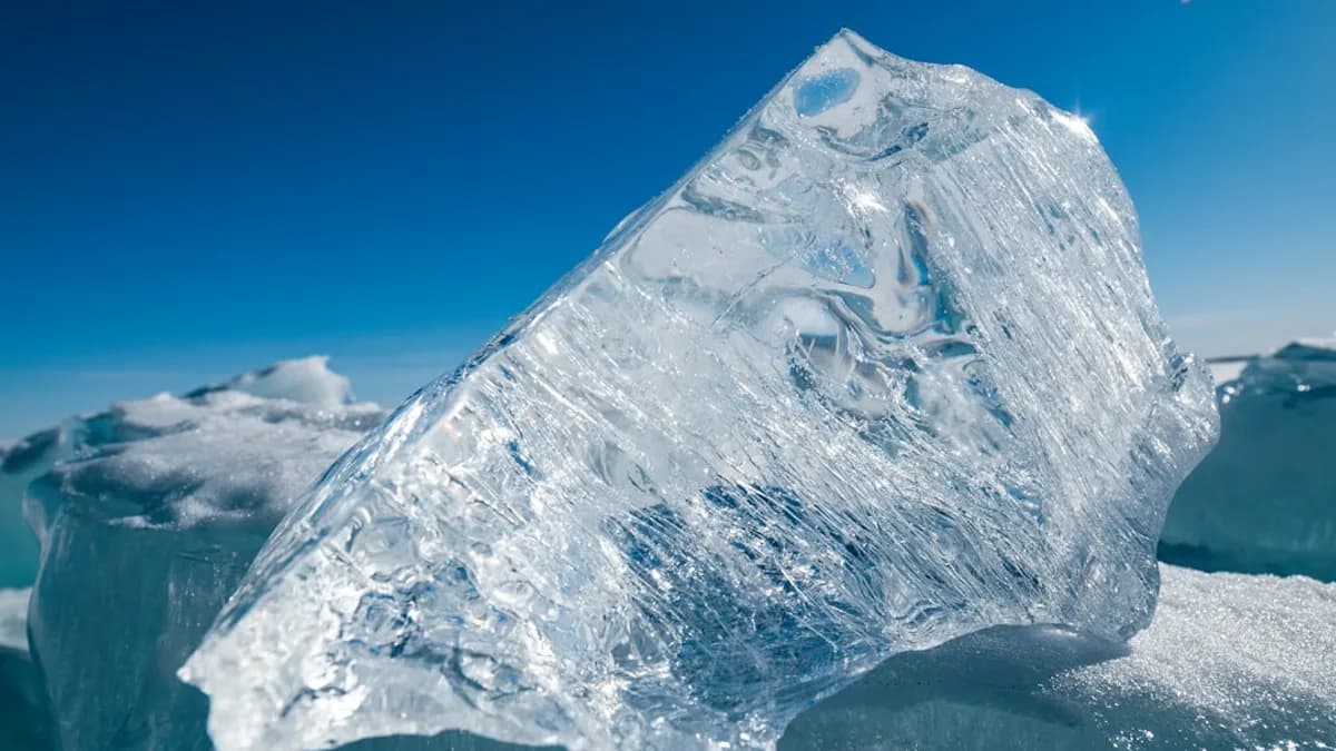 A large iceberg floating on top of a body of water