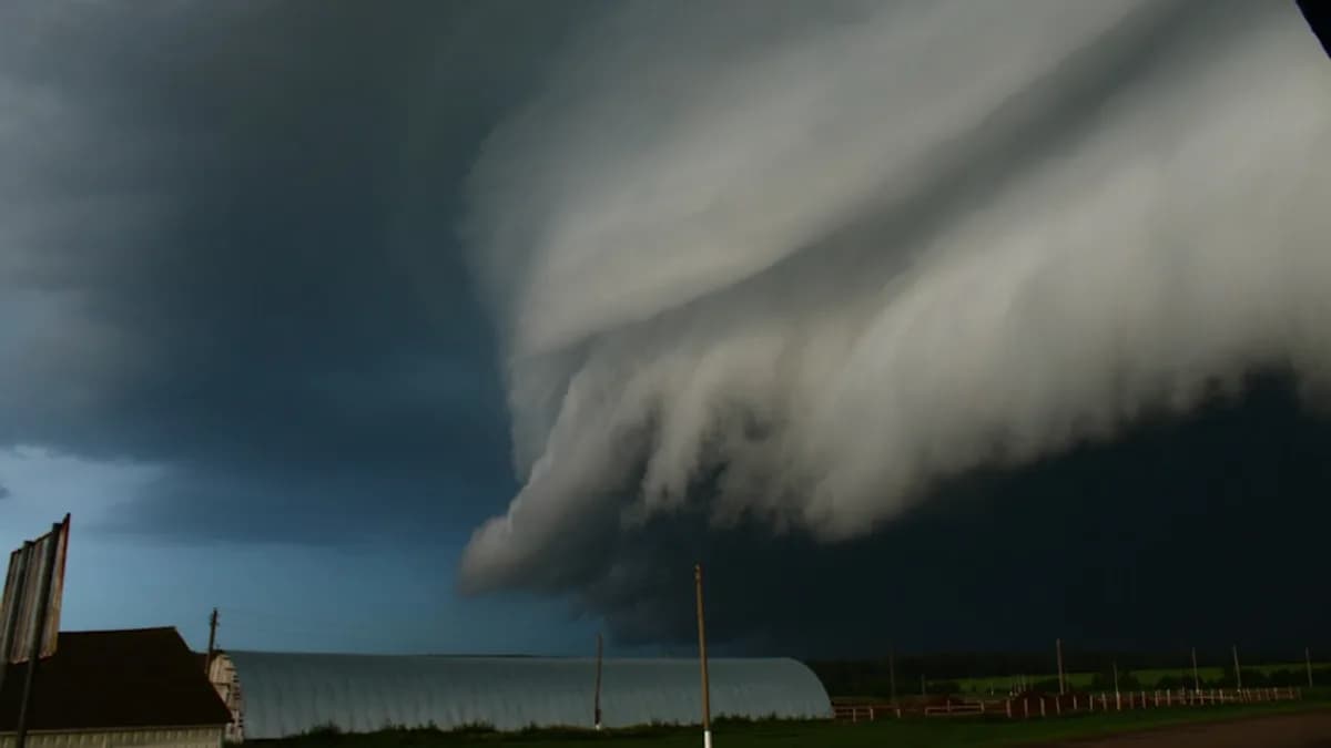 A large cloud is in the sky over a house