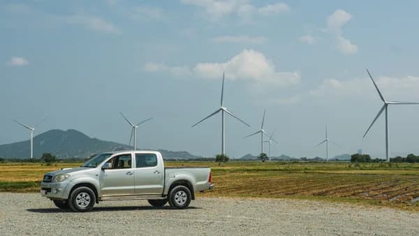 a truck parked in front of windmills
