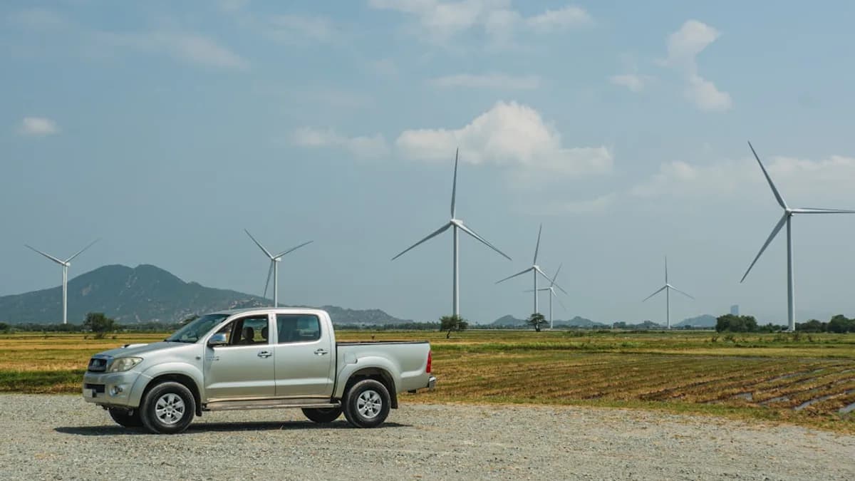 a truck parked in front of windmills