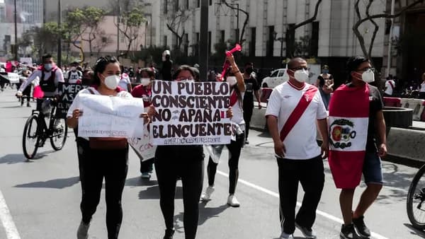 people in white shirt and black pants standing on gray concrete road during daytime
