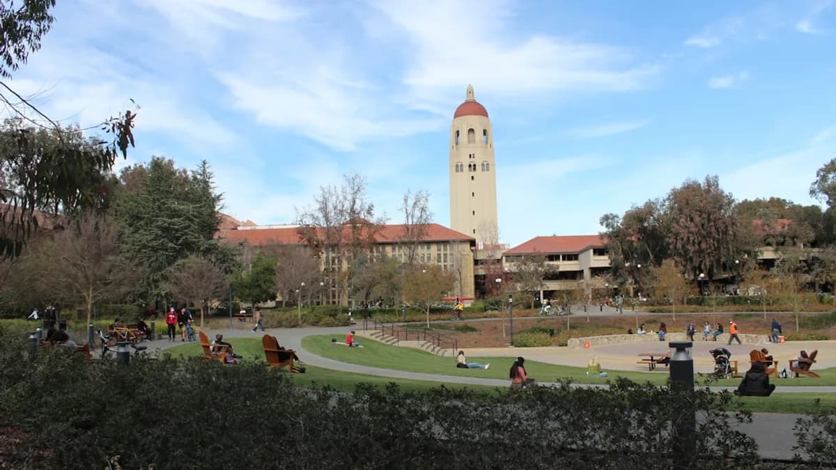 a group of people sitting on a bench in a park