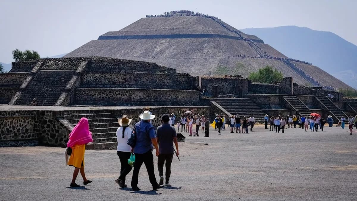 a group of people standing in front of a pyramid
