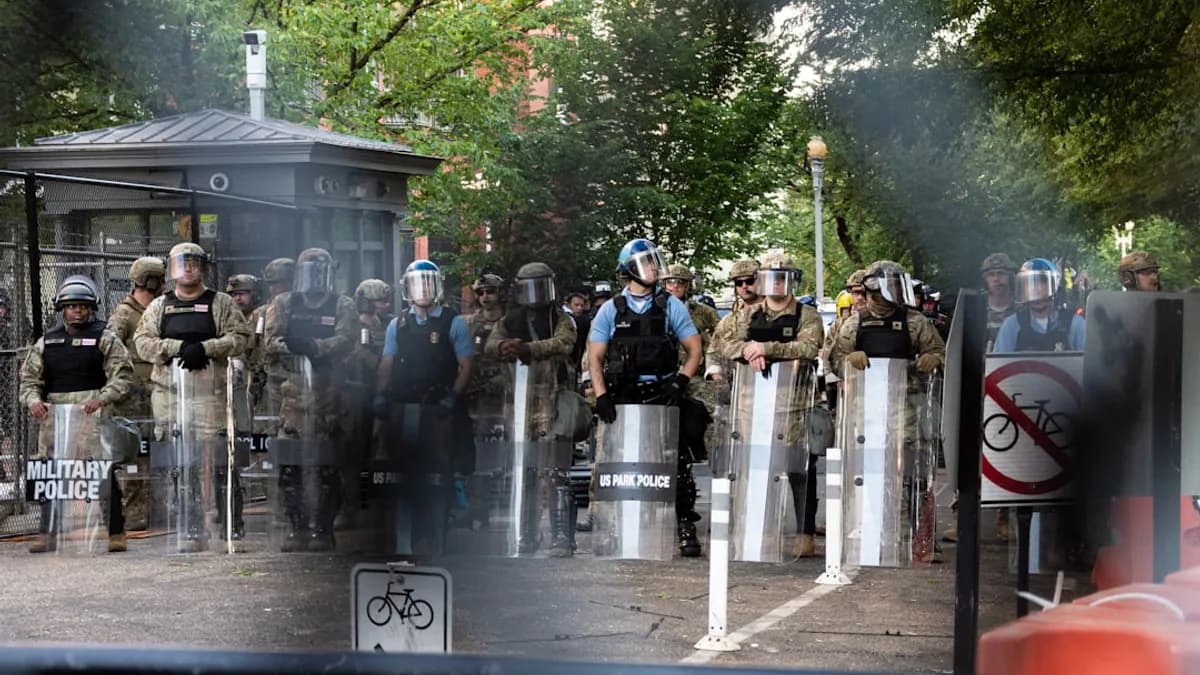 people standing near gray metal fence during daytime