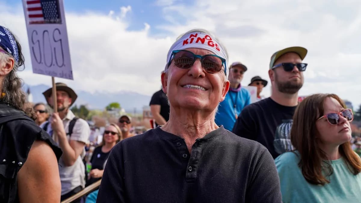 Man in bandana smiles at a rally with crowd