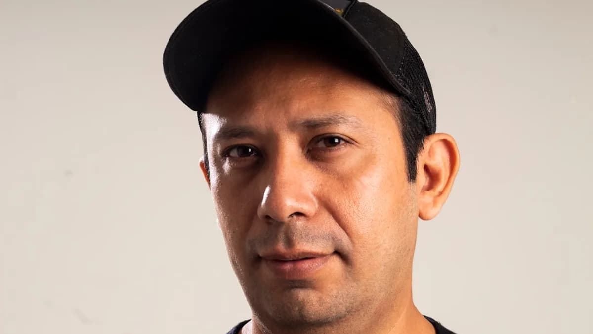 man in black crew neck shirt wearing black cap