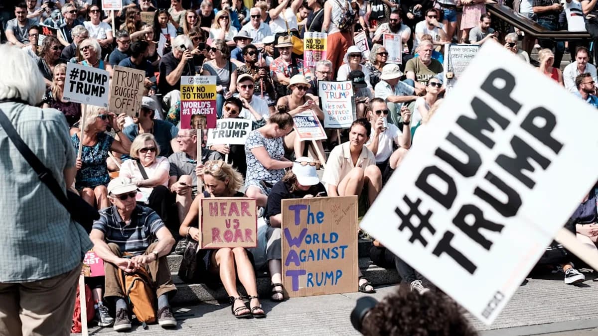 people with banners sitting beside road