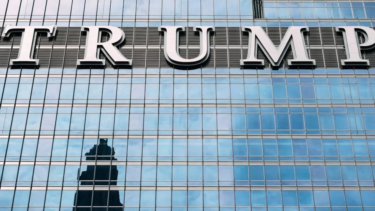 man in black jacket standing in front of glass building