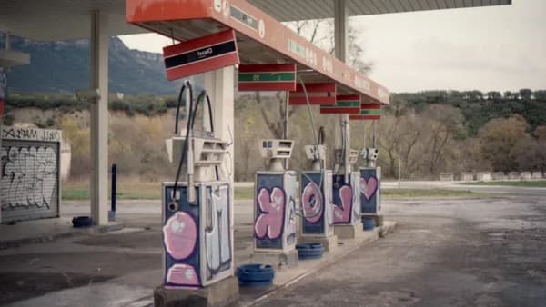 Graffiti-covered gas pumps at an abandoned station