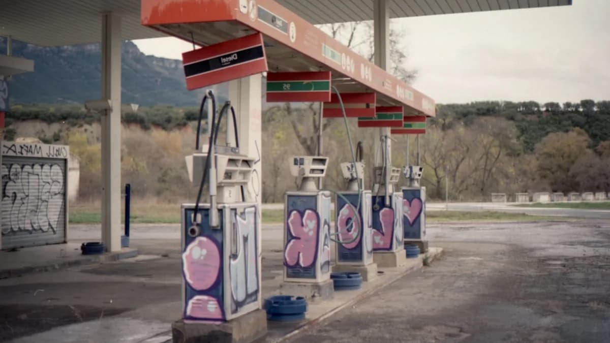 Graffiti-covered gas pumps at an abandoned station
