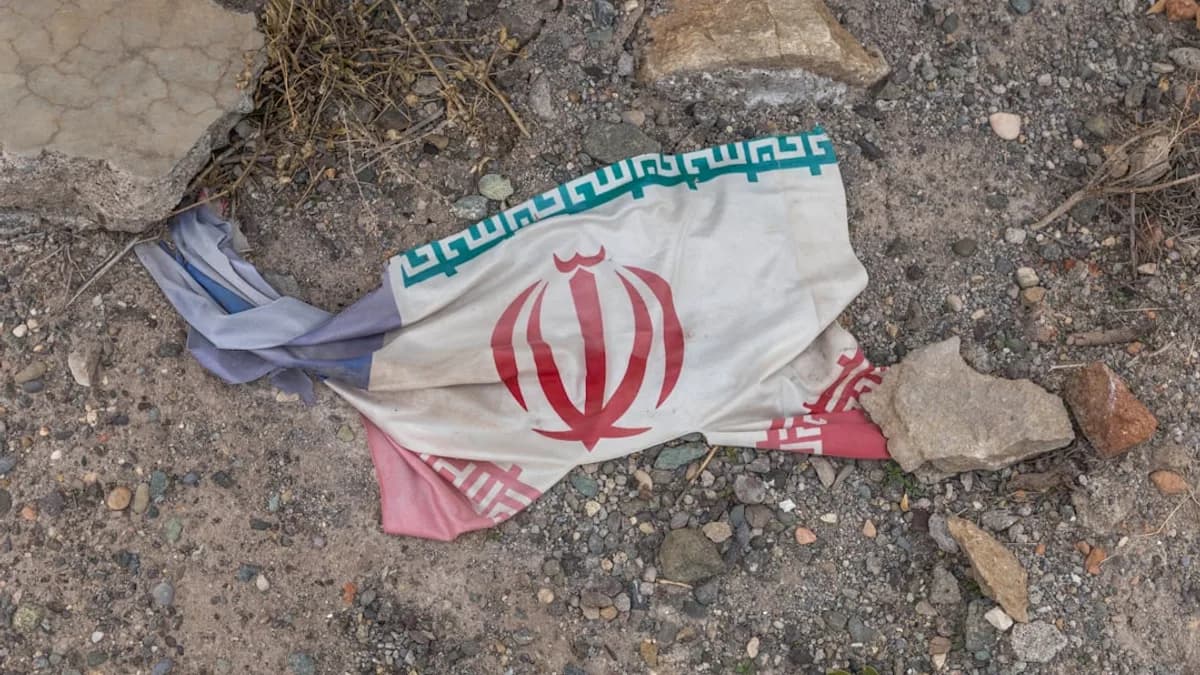 a flag laying on the ground next to rocks