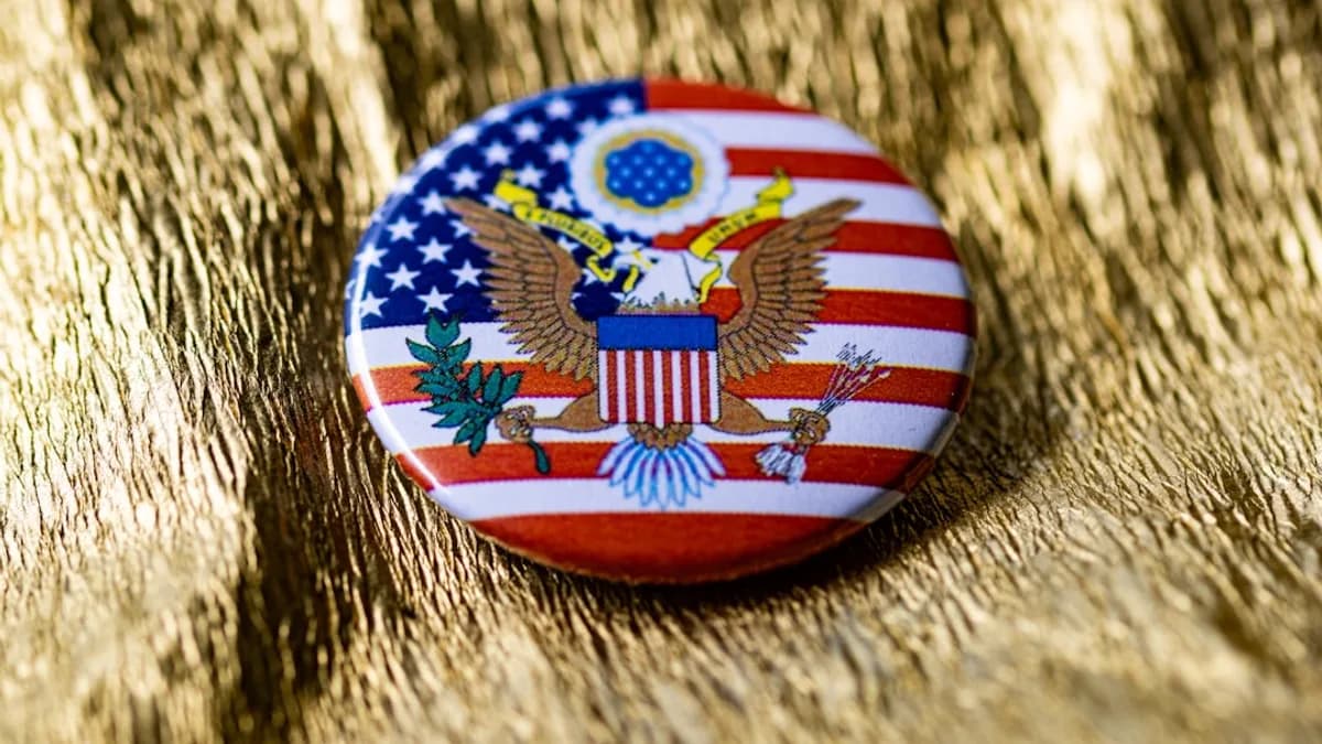 A button with an american flag and eagle on it