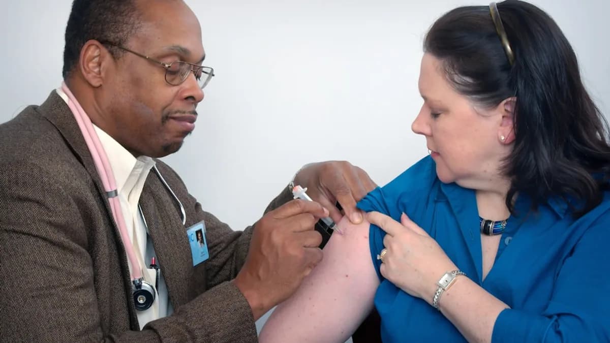man inject woman on right arm