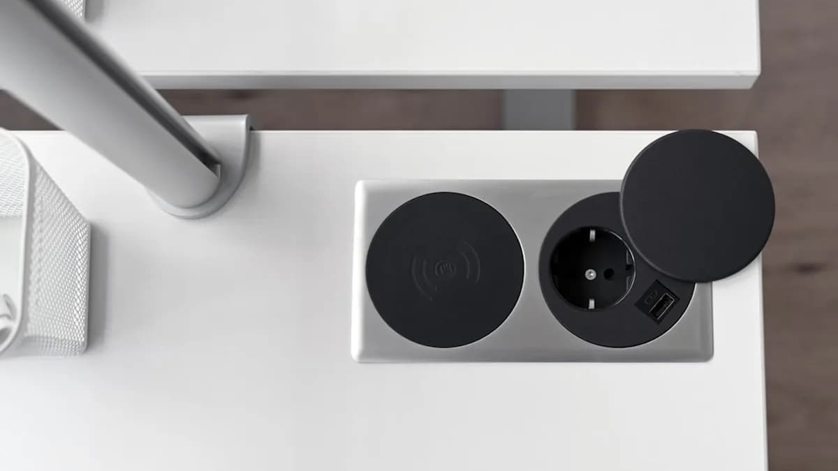 a white table with two black speakers on it
