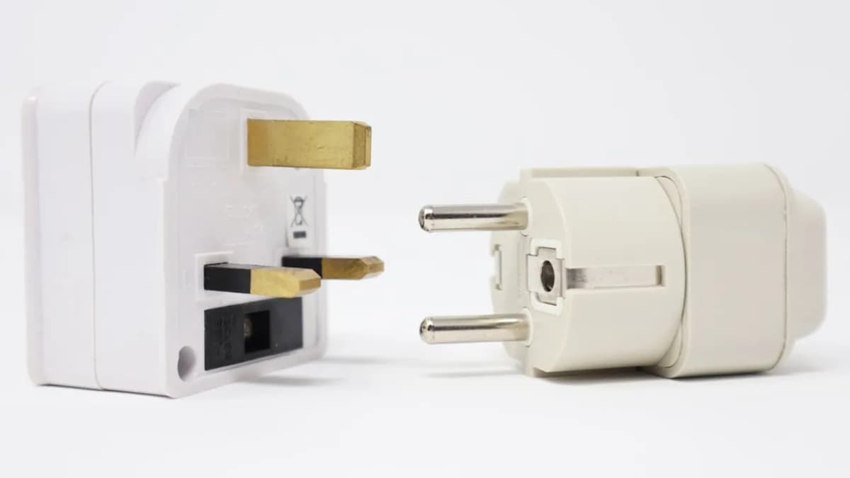 two white power adapters on white background