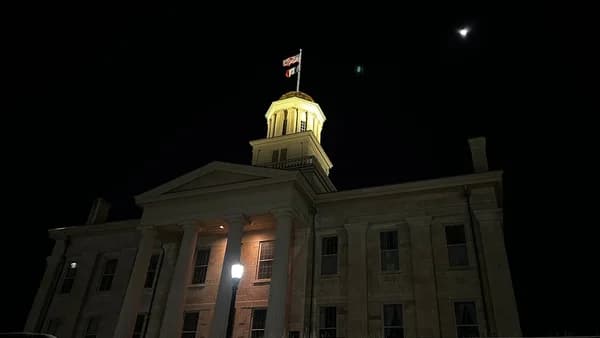a large building with a clock tower at night