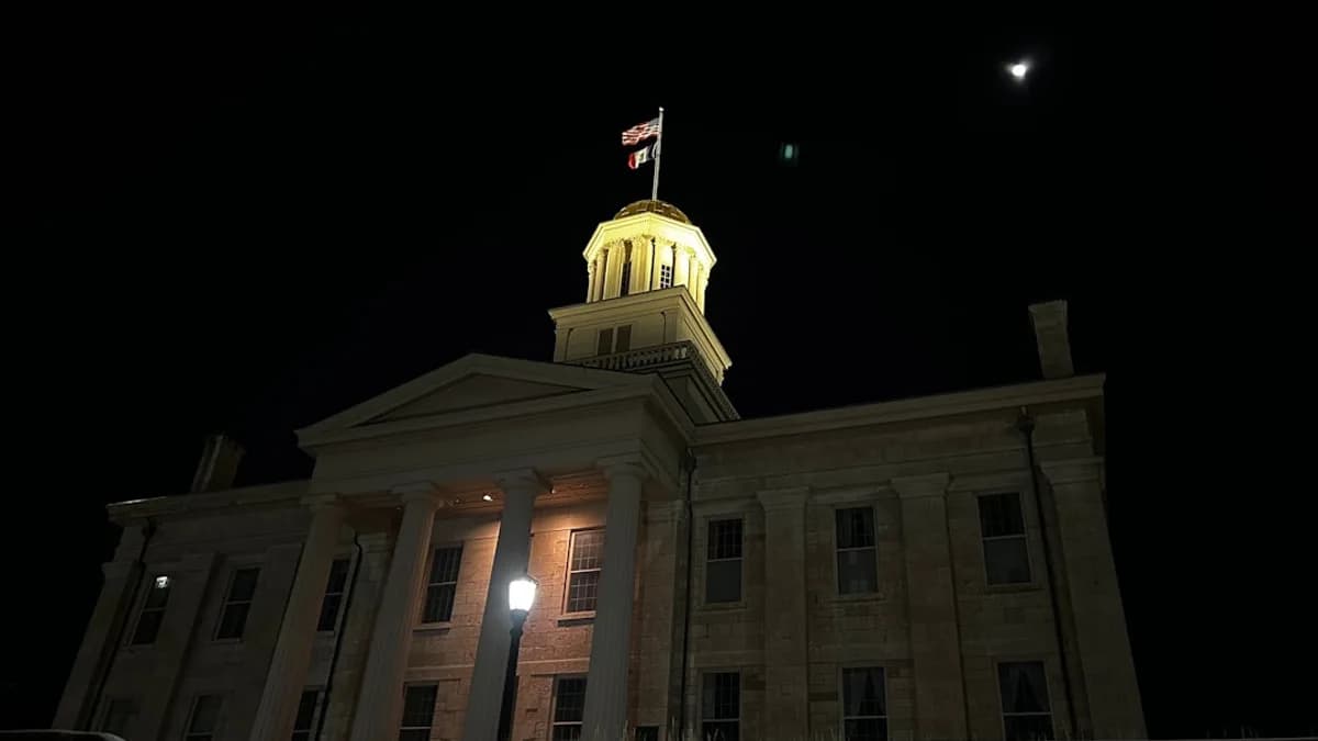 a large building with a clock tower at night
