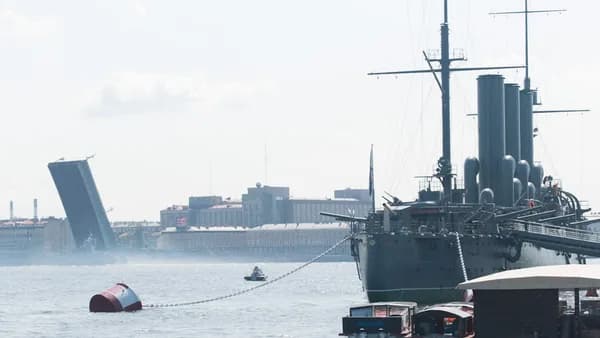 a large boat in the water next to a dock