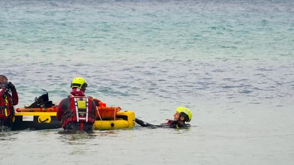 A group of people standing in the water