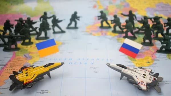 Toy soldiers and jets on world map with flags