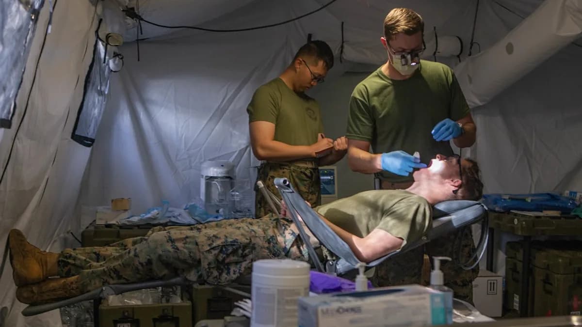 Marines receive dental care inside a tent.