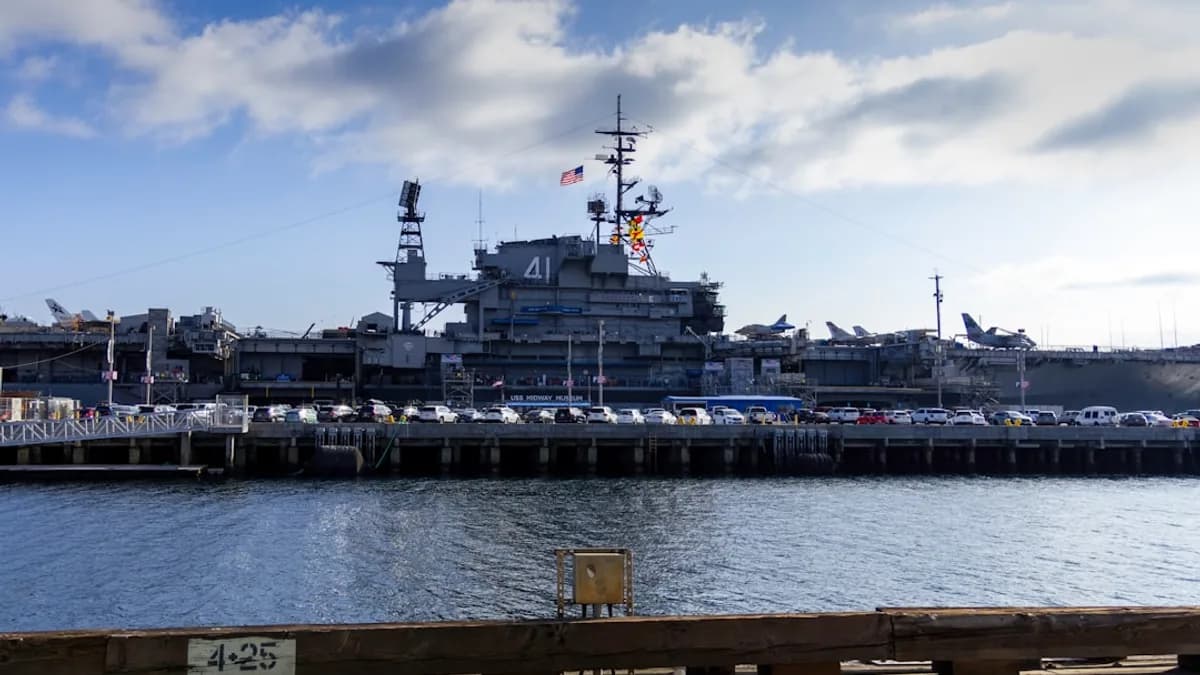 A large ship docked in a harbor next to a pier