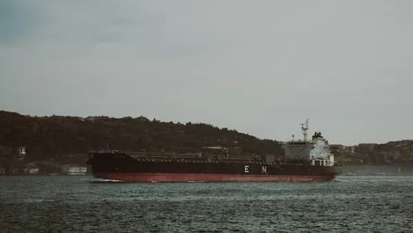 A large cargo ship in the middle of a body of water
