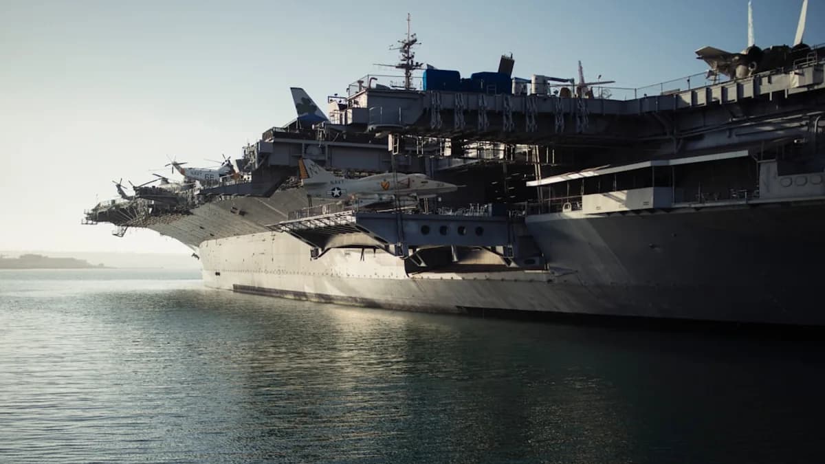 gray warship on body of water