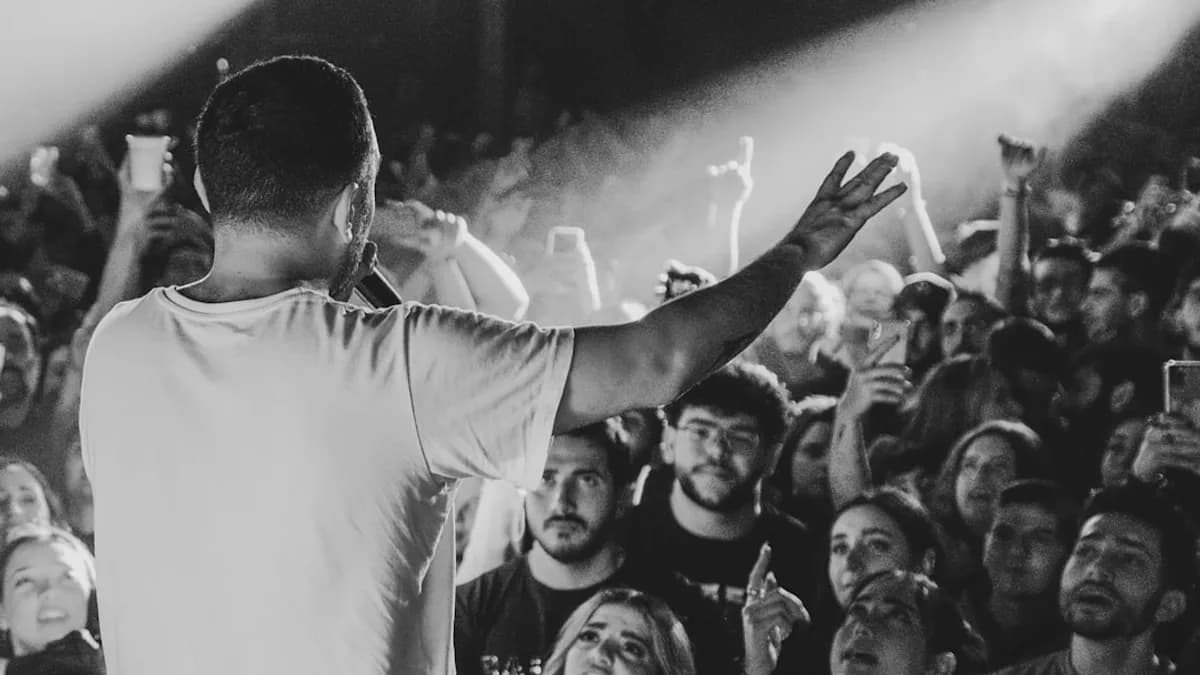 A performer engages with the energetic audience.
