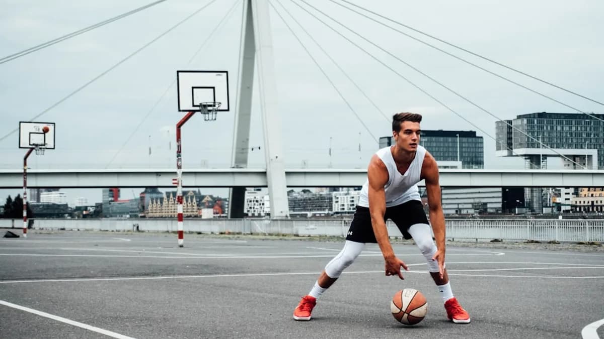 man in black tank top running on road during daytime
