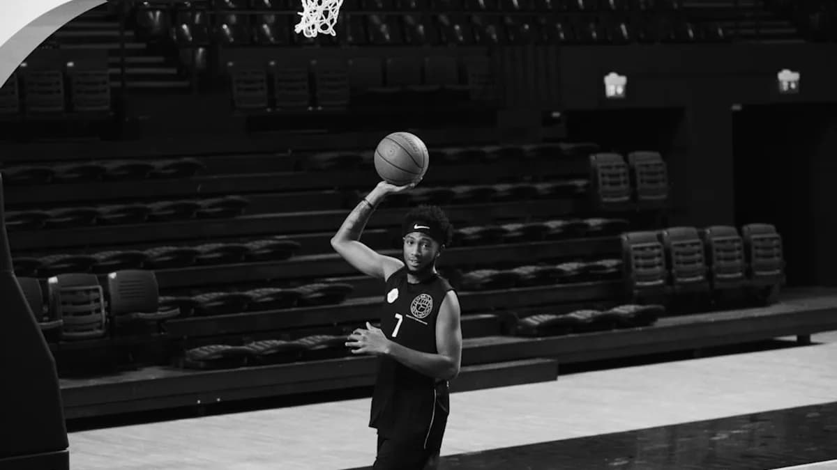 a person holding a basketball in their hand