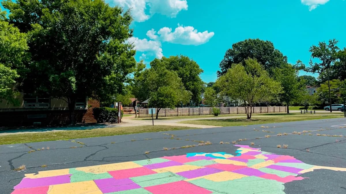 green trees and brown wooden fence under blue sky and white clouds during daytime
