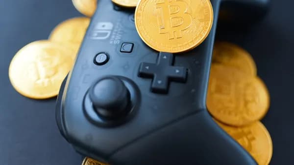 a video game controller surrounded by bitcoins