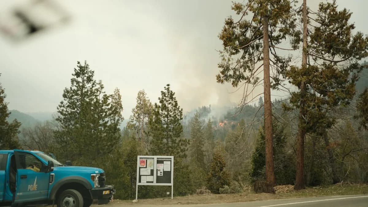 a blue truck parked next to a sign on the side of a road